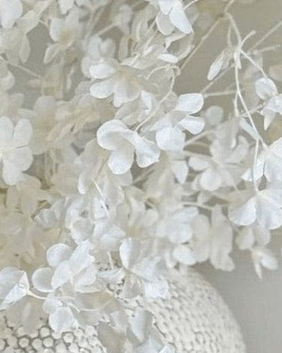 Artificial white blossom stem from Starlight Express, featuring realistic white flower blossoms on a flexible stem.