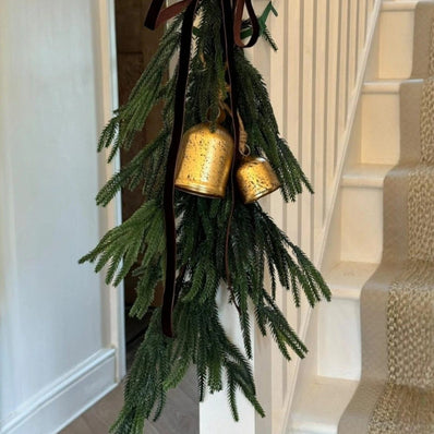 Artificial luxury green spruce Norfolk Christmas swag by Starlight Express, decorated with pinecones and festive greenery.