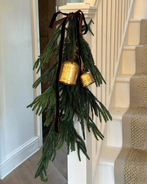 Artificial luxury green spruce Norfolk Christmas swag by Starlight Express, decorated with pinecones and festive greenery.