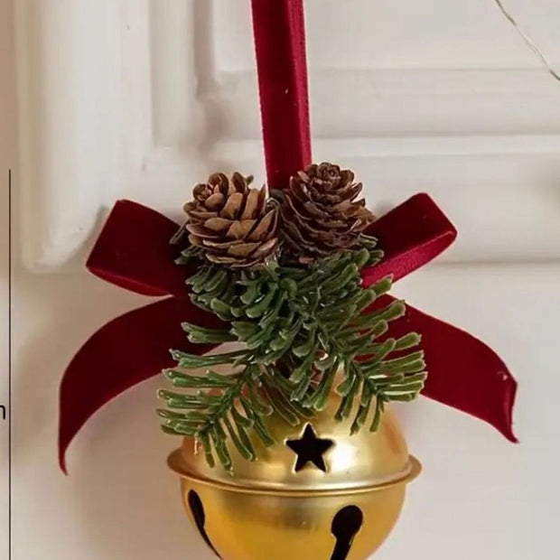 Gold Christmas bell with a burgundy bow, from Starlight Express, hanging as a festive holiday decoration.