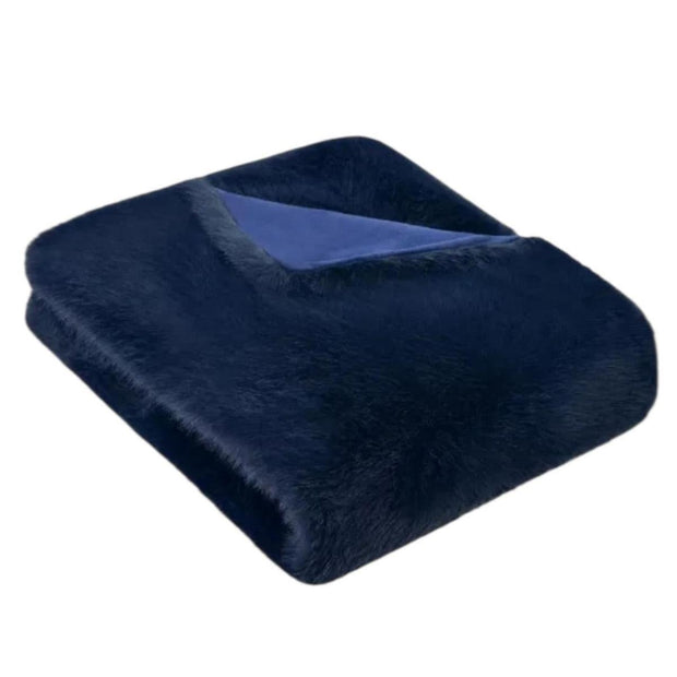 Navy blue Jasper blanket throw by Starlight Express, soft woven fabric with fringed edges, draped over a cozy armchair.