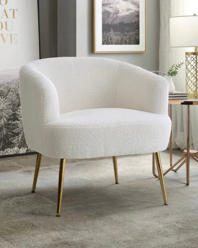 Cream boucle chair with gold hairpin legs from Starlight Express, modern furniture piece with plush upholstery and sleek design.