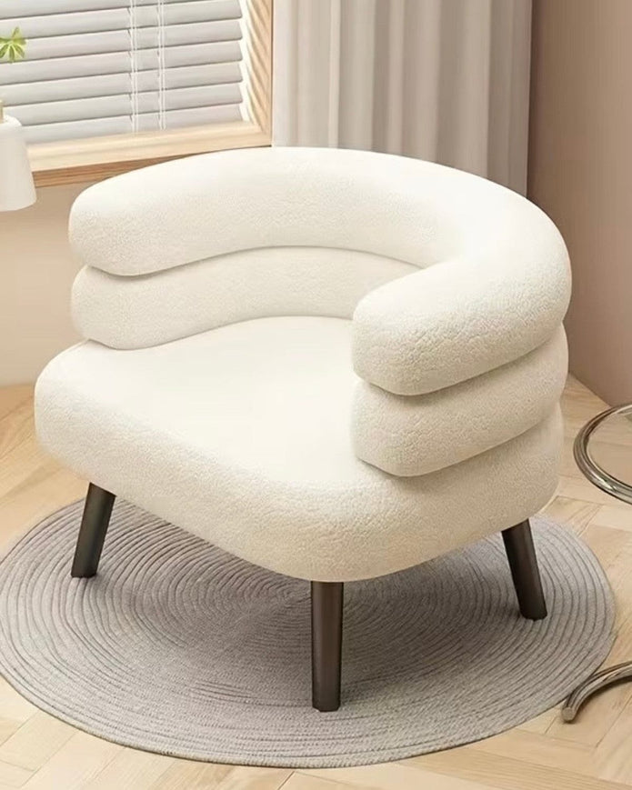 Cream boucle curved chair with wooden legs from Starlight Express, showcasing its plush upholstery and modern design.