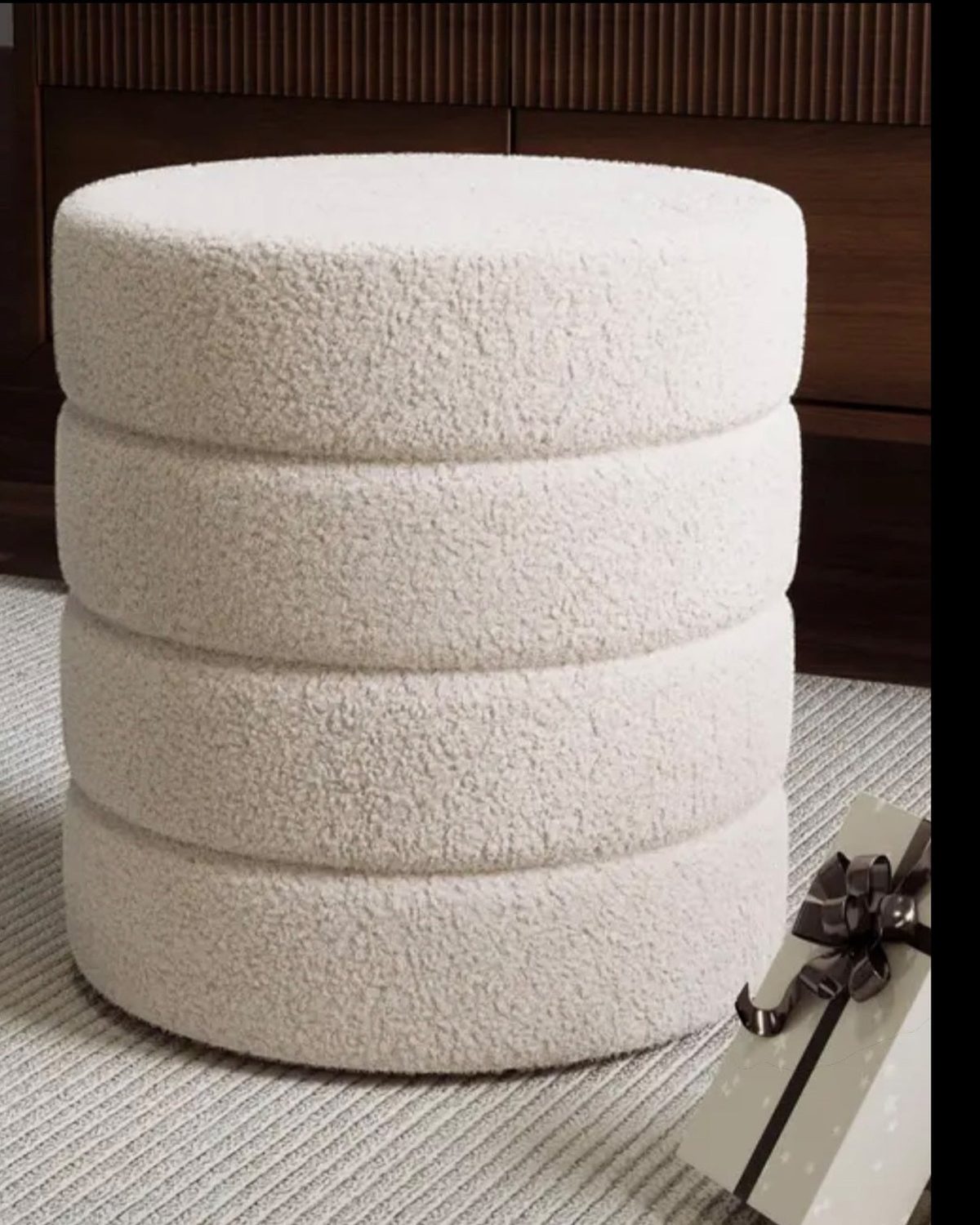 Cream boucle ribbed round foot stool by Starlight Express, showcasing soft textured upholstery and sturdy wooden legs.