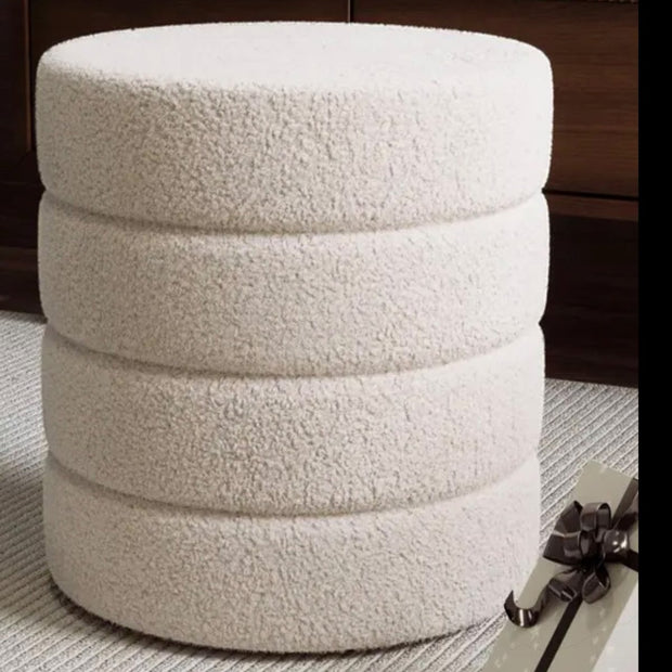 Cream boucle ribbed round foot stool by Starlight Express, showcasing soft textured upholstery and sturdy wooden legs.