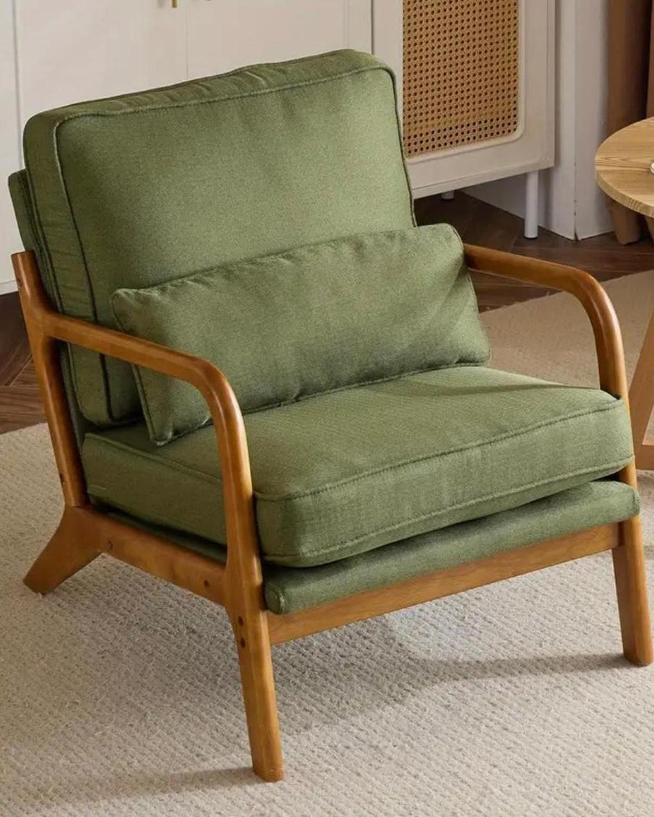 Green retro wooden framed arm chair from Starlight Express, showcasing vintage-inspired furniture with plush upholstery.