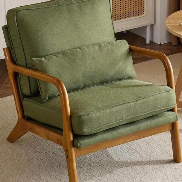 Green retro wooden framed arm chair from Starlight Express, showcasing vintage-inspired furniture with plush upholstery.
