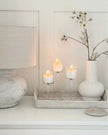 Set of three stemmed glass candle holders for home decor by Starlight Express, featuring elegant transparent glass designs.