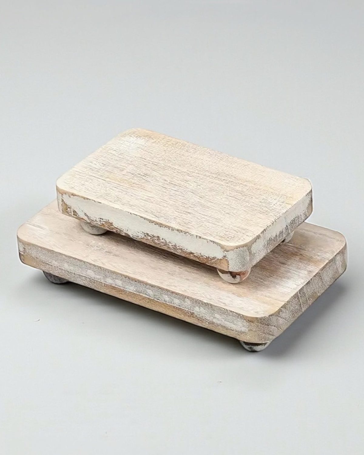 Set of two white wood chunky risers for home décor, featuring natural wood finish and sturdy block design.