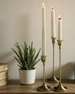 Antique brass effect taper candlestick for home decor, featuring a classic design and warm metallic finish by Starlight Express.