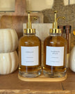Gold coffee syrup dispenser and label set by Starlight Express, kitchen accessory for coffee stations, with pump and labeled bottles.