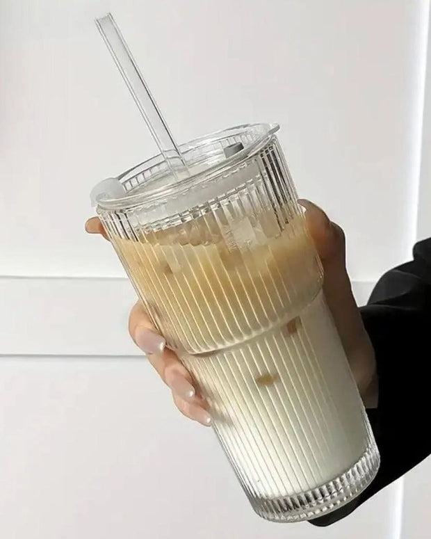 Large ribbed glass ice coffee tumbler with lid by Starlight Express, ideal for cold beverages in kitchen and dining settings.