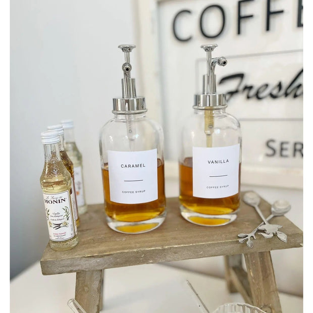 Silver Starlight Express coffee syrup dispenser with label set, kitchen and dining accessory for syrup or oil storage.