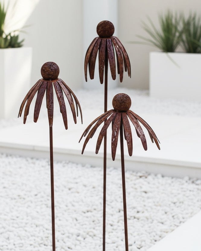 Rusty metal flower head garden stake by Starlight Express, outdoor decor with detailed flower design for garden embellishment.