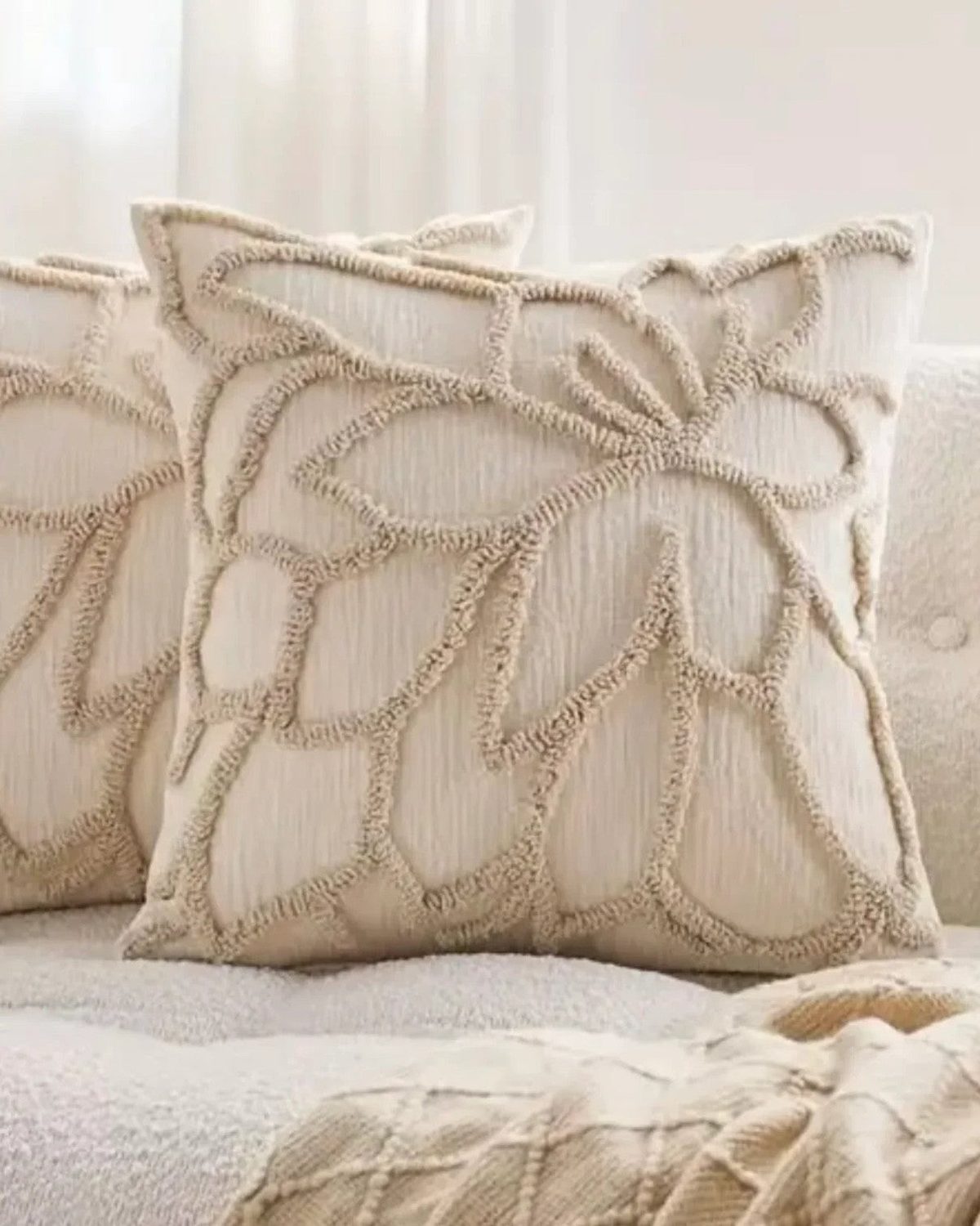 Beige flower embroidered boucle cushion cover by Starlight Express, soft furnishings, with floral embroidery and textured boucle fabric.