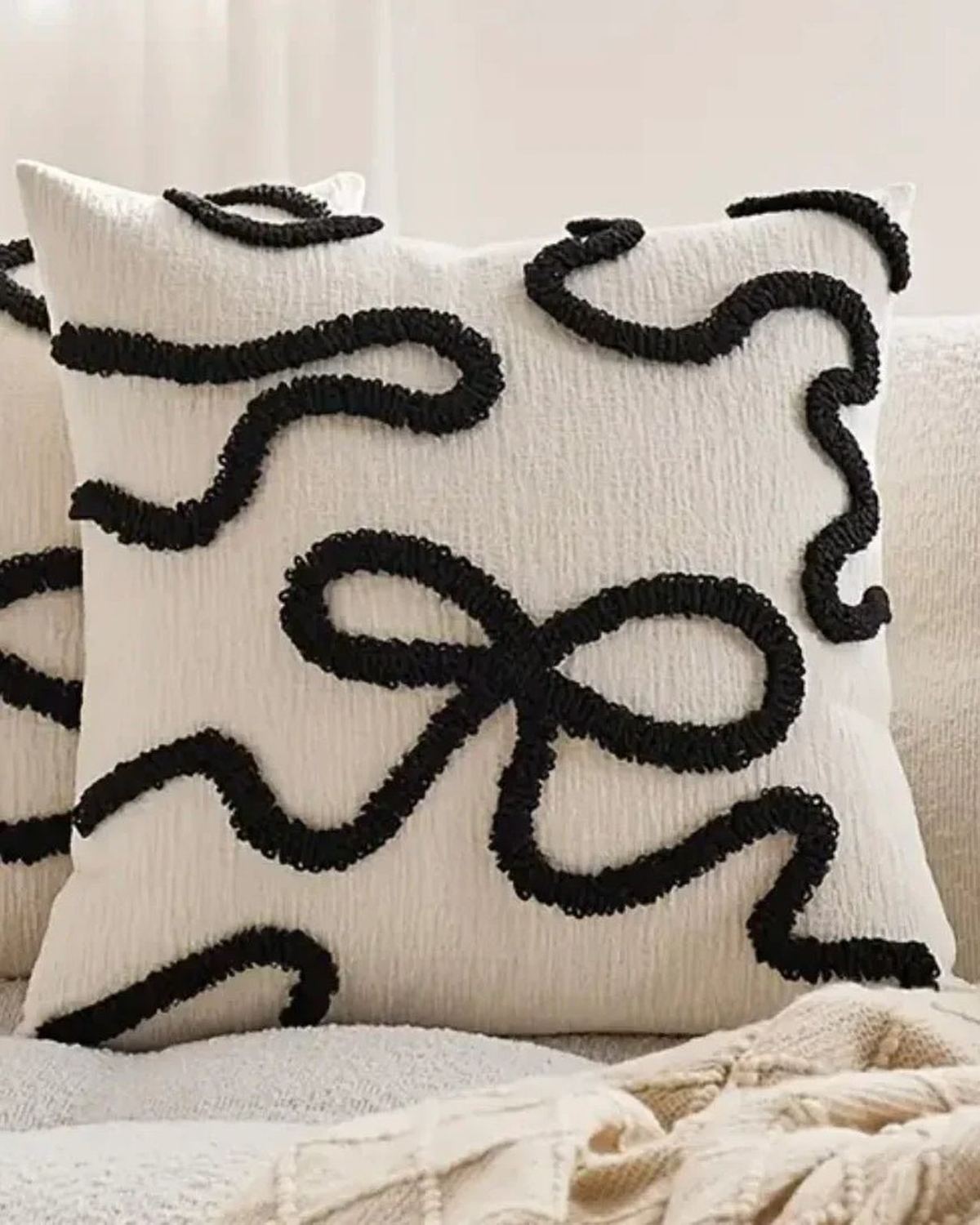 Black embroidered cushion cover with bow design from Starlight Express, soft furnishings accessory for decorative home decor.