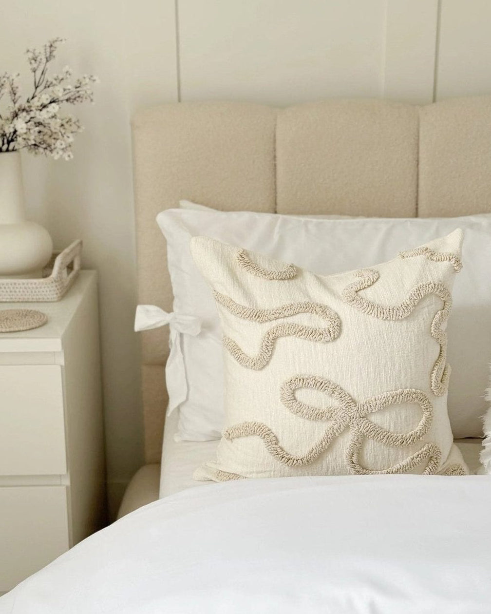 Cream and beige bow square boucle cushion cover by Starlight Express, soft furnishings with a textured boucle fabric and decorative bow detail.