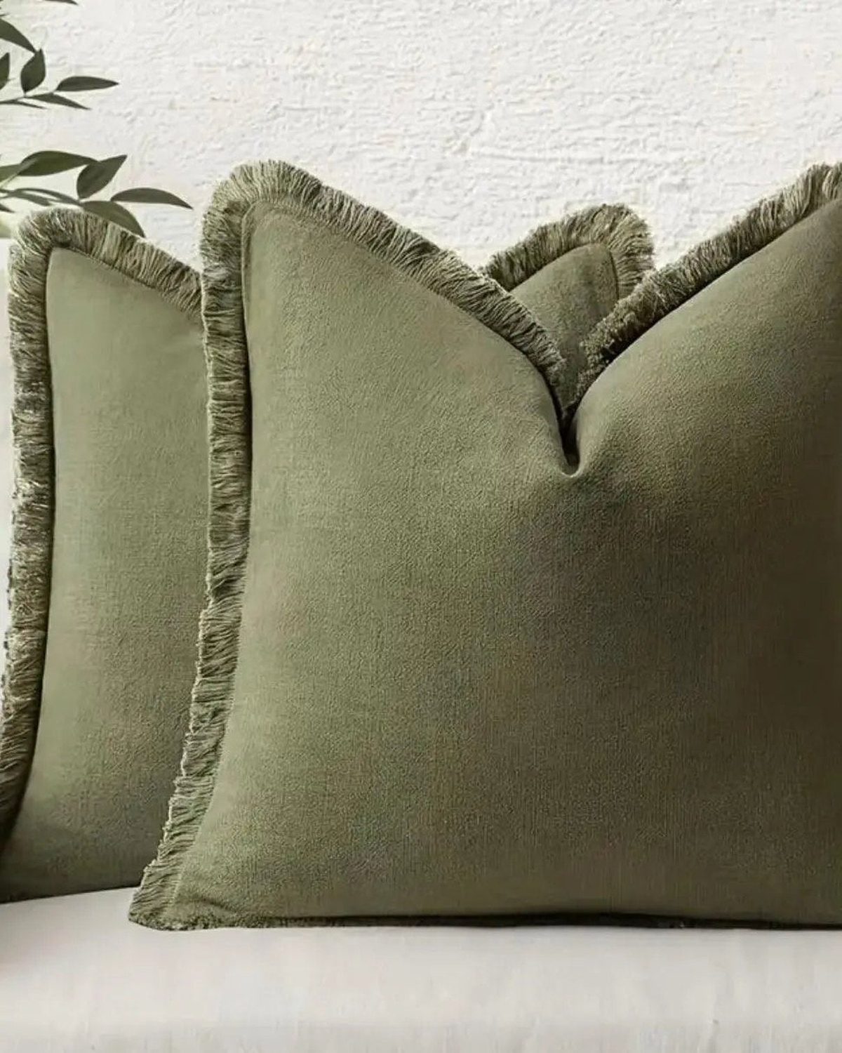 Olive green cushion cover with frayed edges by Starlight Express, made from soft furnishings material, showcasing a textured design.