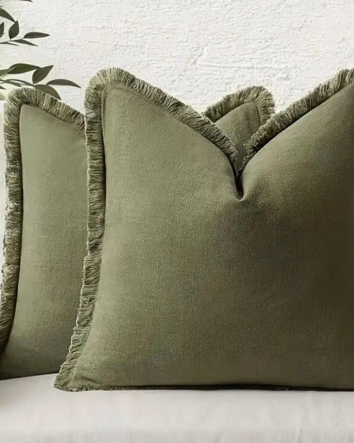 Olive green cushion cover with frayed edges by Starlight Express, made from soft furnishings material, showcasing a textured design.