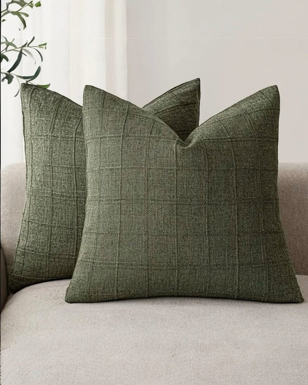 Olive green woven square cushion cover with intricate design, soft furnishings by Starlight Express, fabric texture visible.