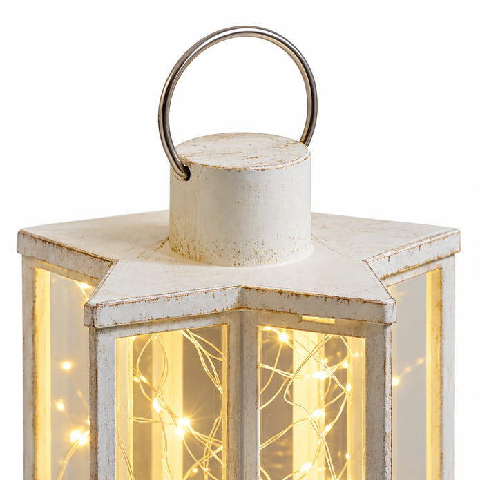 Close-up of the Starlight lantern's cream star-shaped top and metal hanging handle.