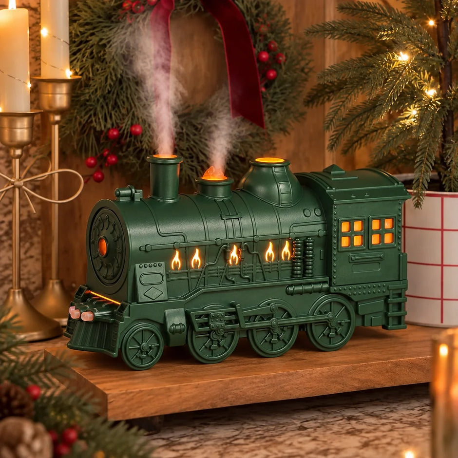 Green steam train oil diffuser with glowing windows and mist in a Christmas display