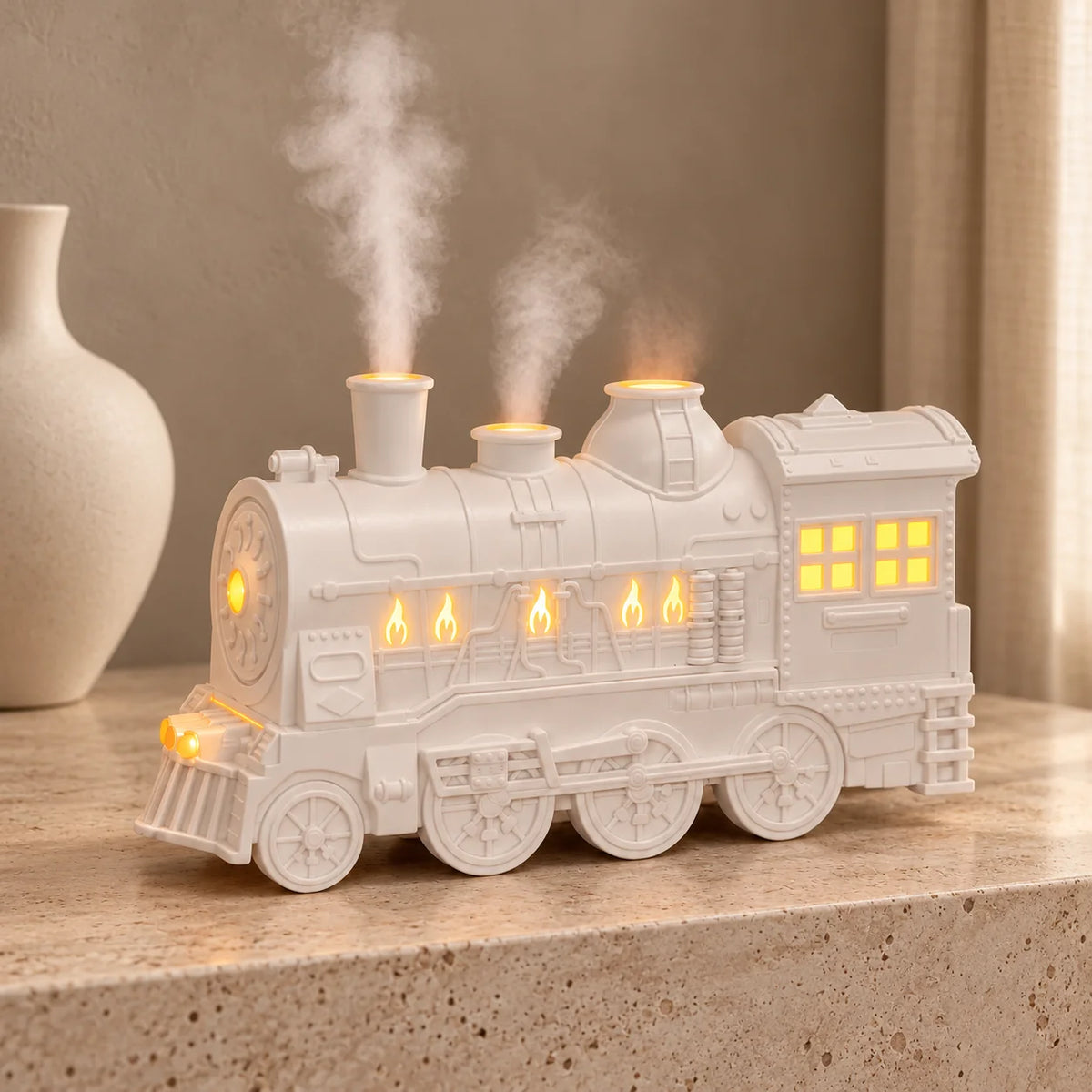 White steam train oil diffuser with glowing windows and rising mist