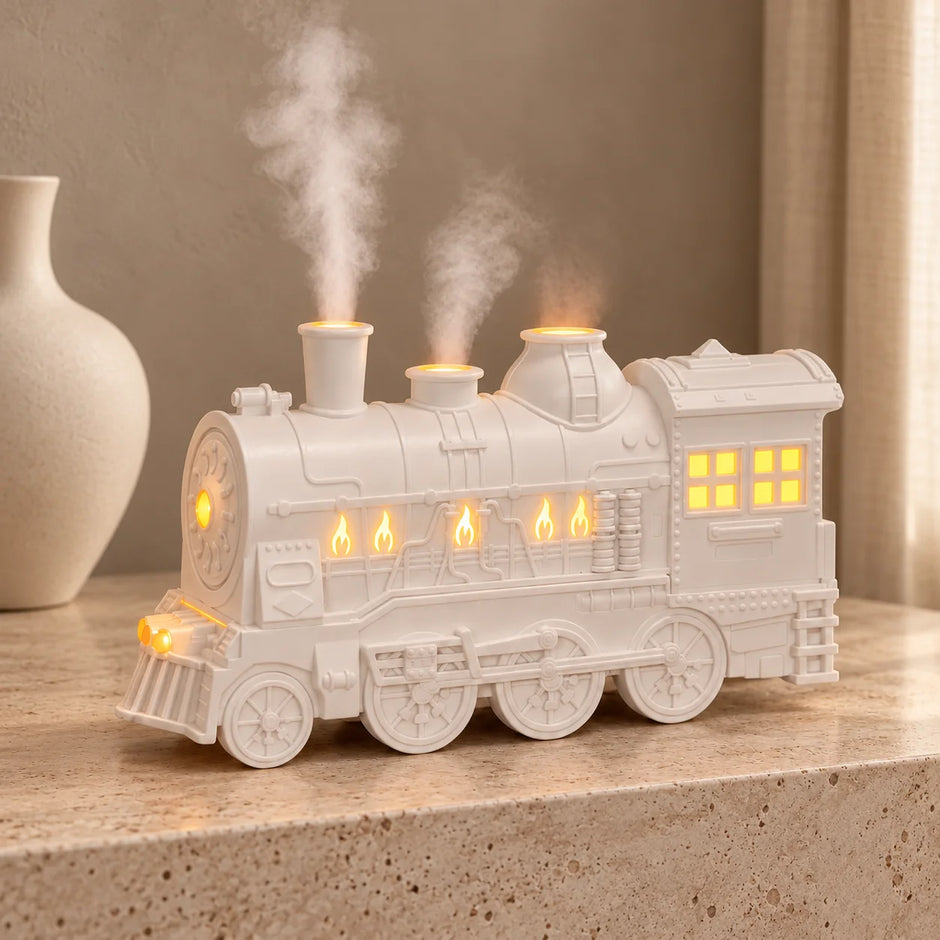 White steam train oil diffuser with glowing windows and rising mist