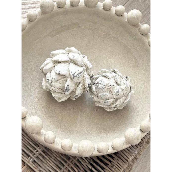 Stone Concrete Decorative Artichoke, two pale stone artichokes viewed from above on a beaded dish