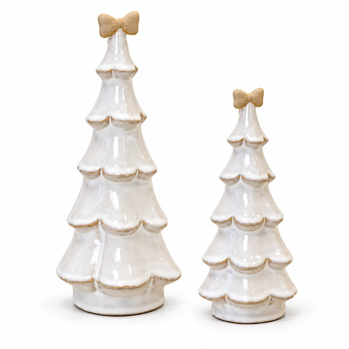 Medium and large stone-glazed ceramic Christmas trees with cream bows, on a white studio background.