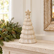 Stone glazed ceramic Christmas tree on a limestone mantel