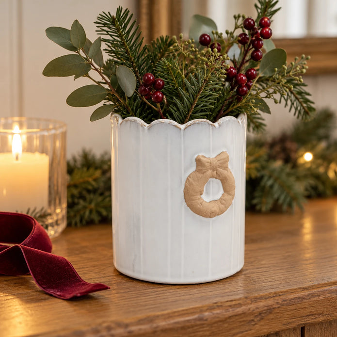 Stoneglazed Christmas wreath pot with winter greenery on an oak console