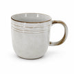 Single empty stoneware coffee mug with brown rim and curved handle on white