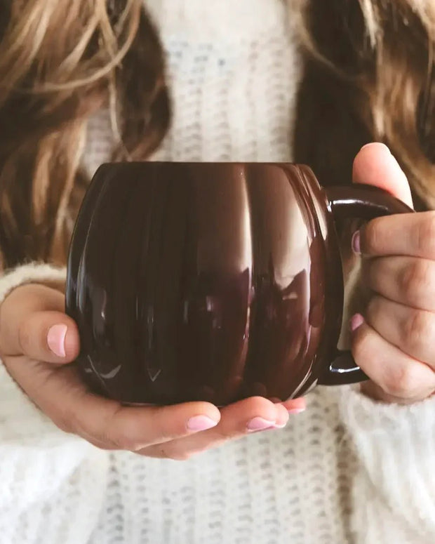 Brown ceramic pumpkin mug by Sweet Water Decor, perfect for autumn décor and cozy seasonal drinks.