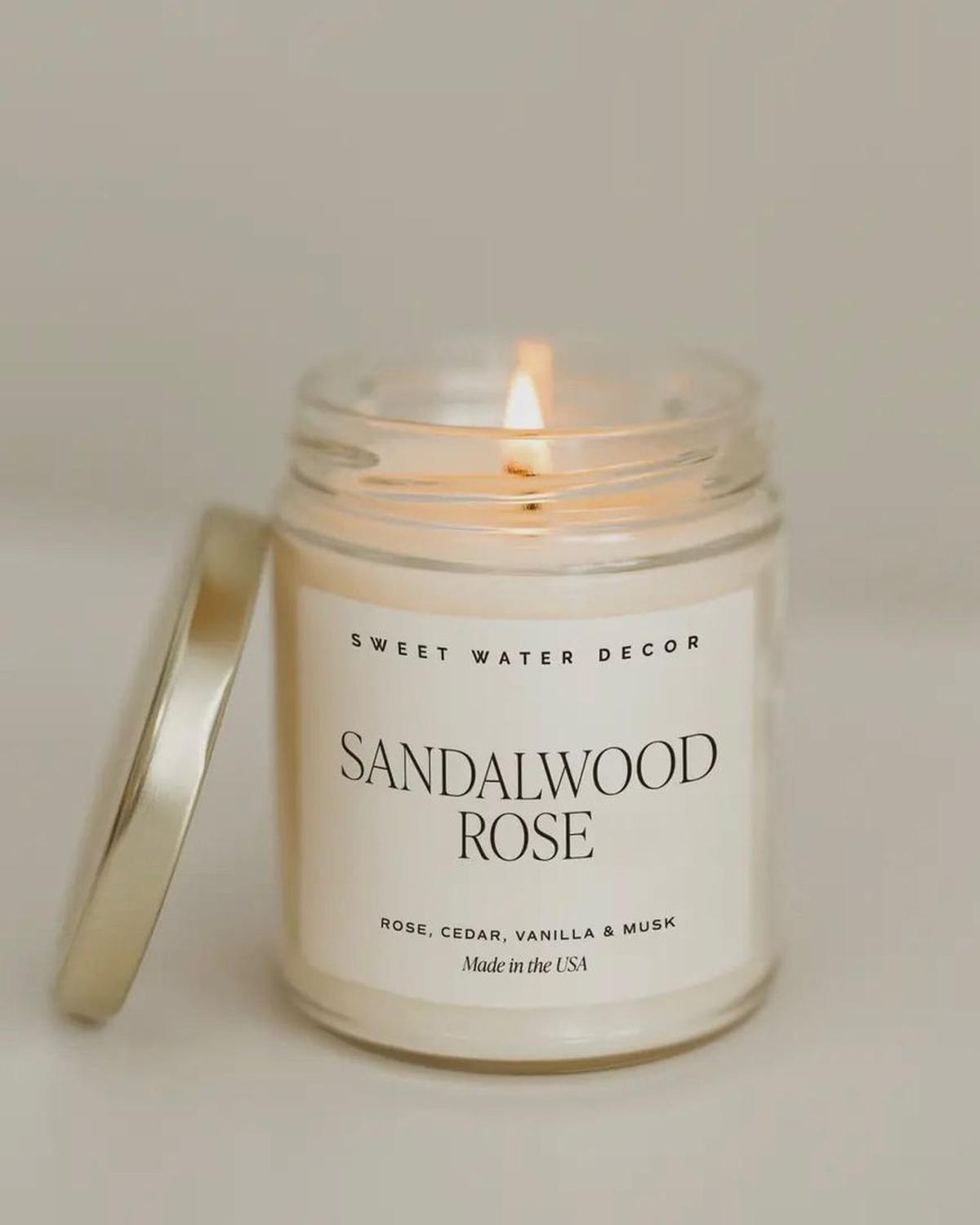 Sweet Water Decor clear glass candle jar with sandalwood rose scented candle, showcasing elegant design and natural fragrance.