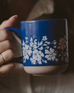 Blue floral stoneware coffee mug by Sweet Water Decor with a modern, decorative design and sturdy handle.
