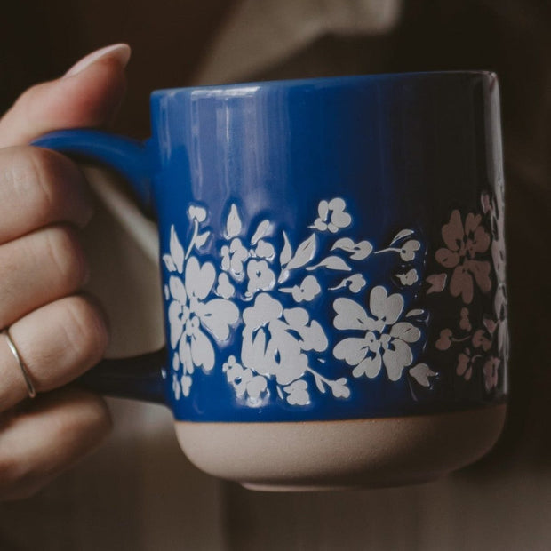 Blue floral stoneware coffee mug by Sweet Water Decor with a modern, decorative design and sturdy handle.