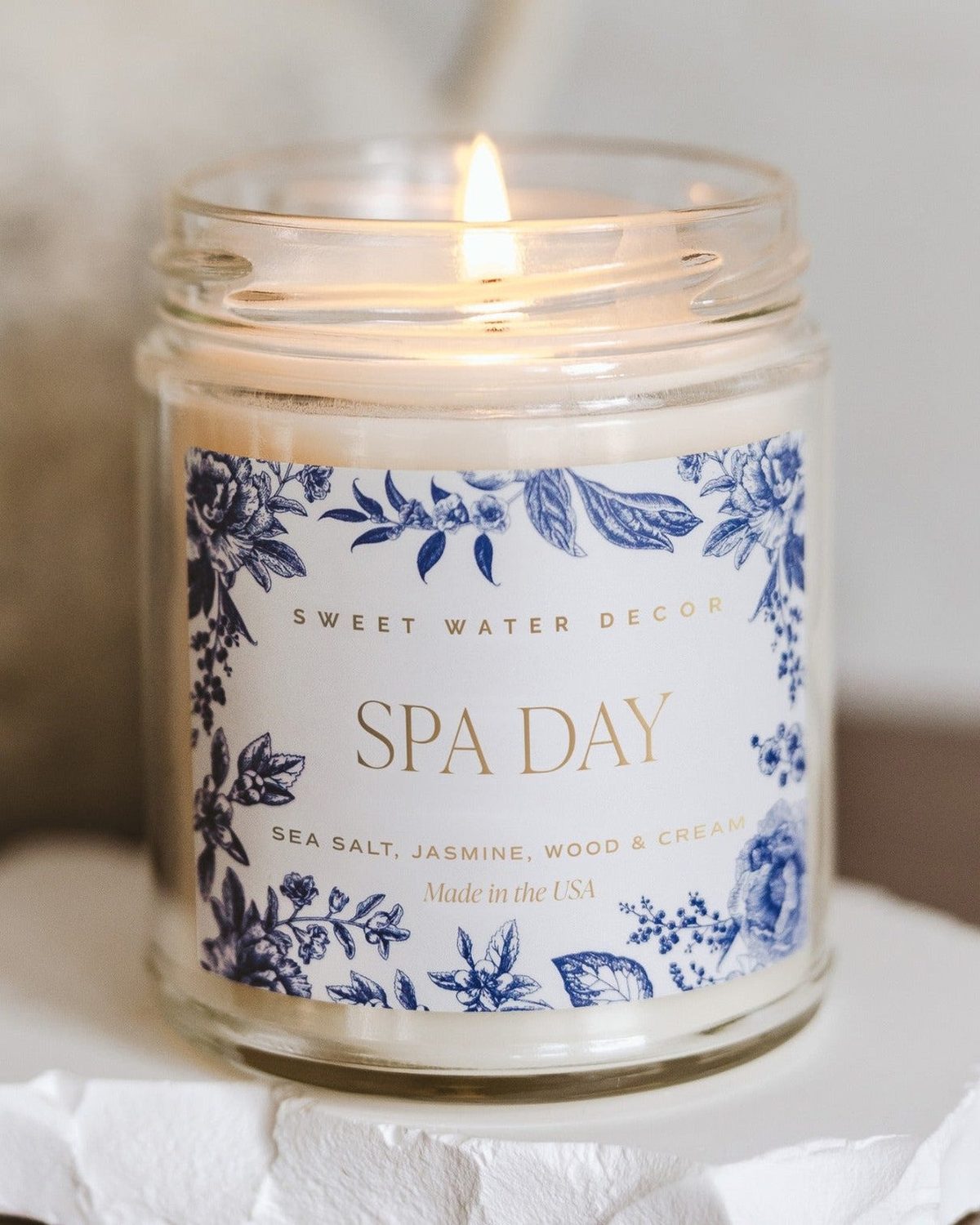 Clear glass candle jar from Sweet Water Decor with a spa day theme, perfect for relaxing candle displays.