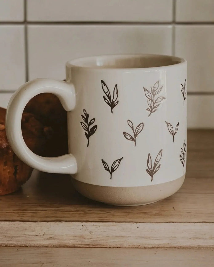 Cream glazed ceramic mug with brown leaf design by Sweet Water Decor, perfect for kitchen and dining use.