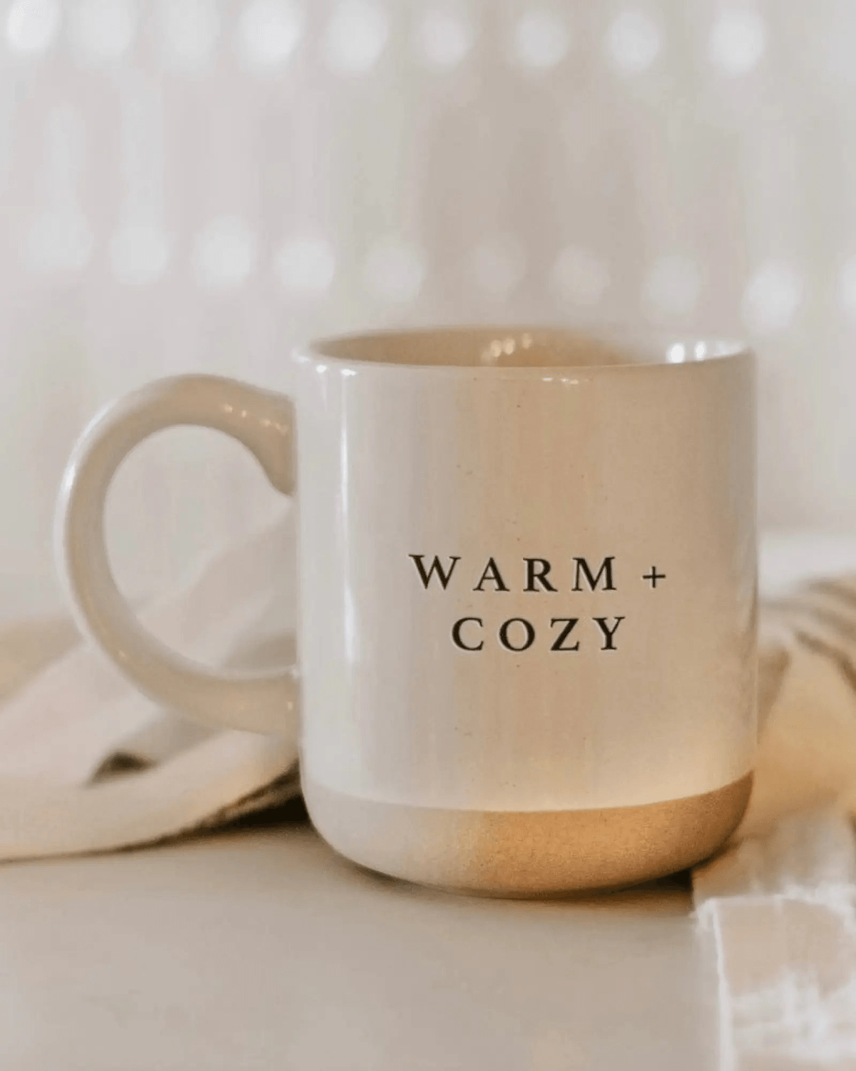 Cream glazed ceramic mug by Sweet Water Decor, perfect for warm beverages, in a cozy kitchen and dining setting.