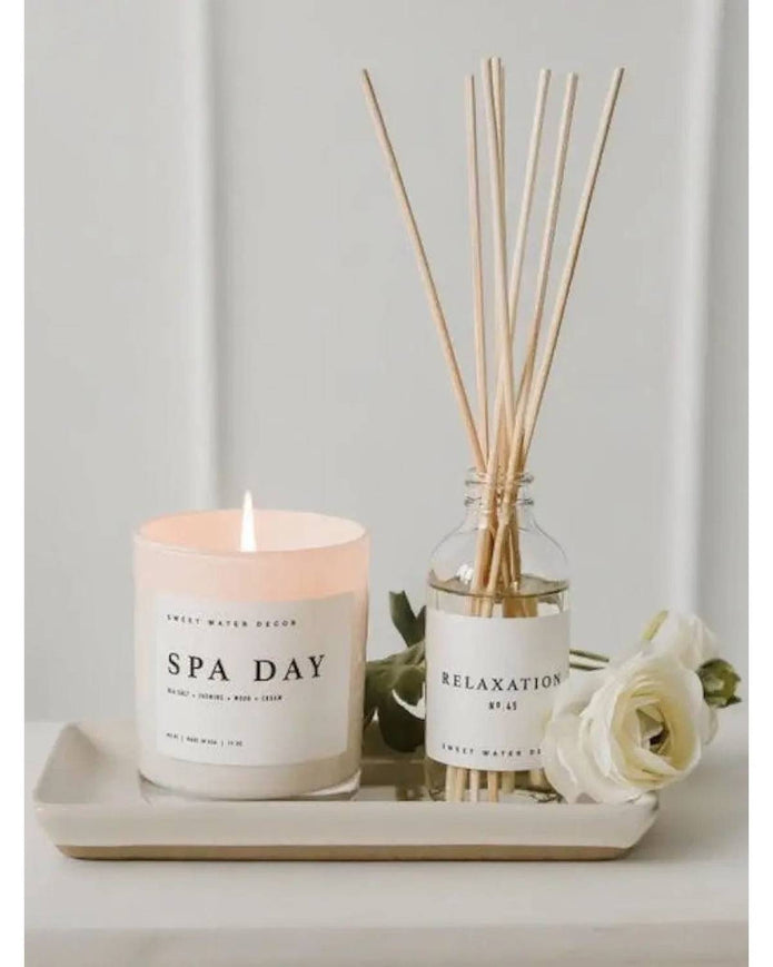 Sweet Water Decor clear glass reed diffuser for relaxation, with reed sticks and calming scent visible in the image.