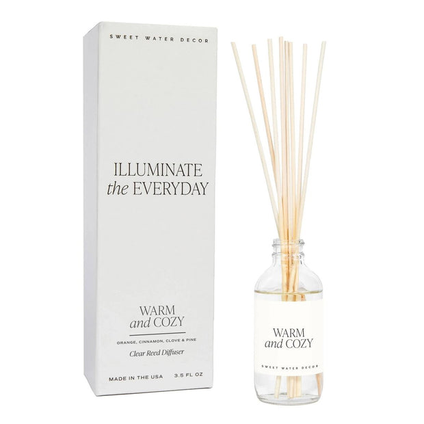 Sweet Water Decor reed diffuser with a sleek glass bottle and natural reeds, designed to add warmth and coziness to your space.