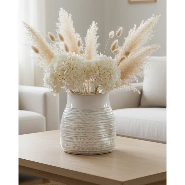 White ceramic vase with a textured surface and wide neck from Hill Interiors, designed for decorative floral arrangements.
