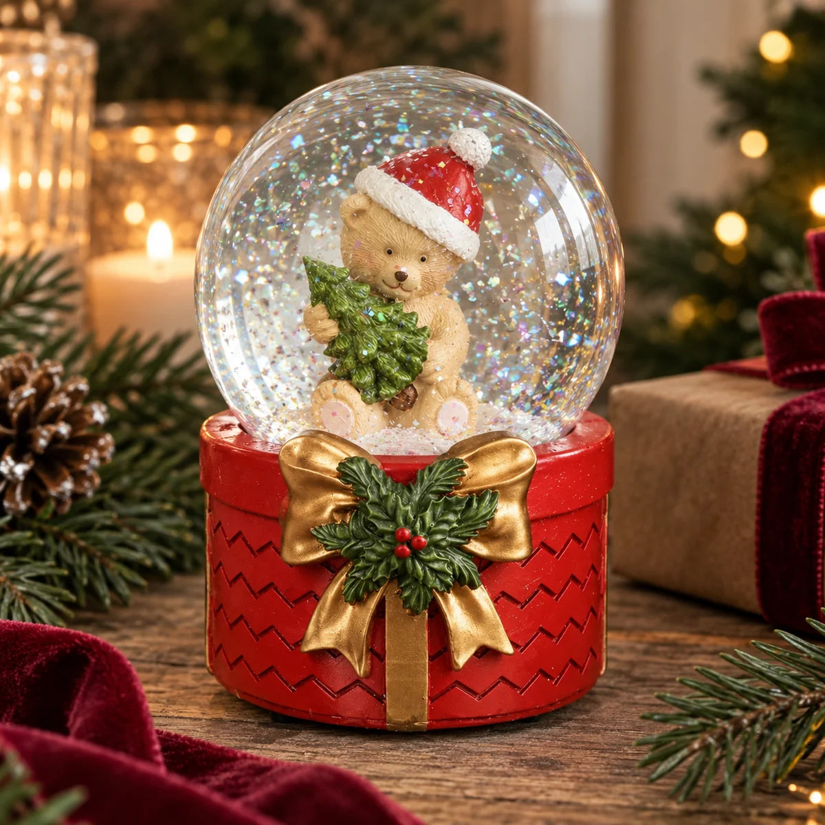Teddy bear snow globe with gold bow and holly on a rustic Christmas table with velvet ribbon