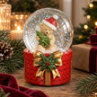 Teddy bear snow globe with gold bow and holly on a rustic Christmas table with velvet ribbon