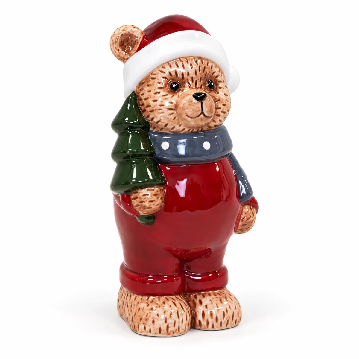 Teddy bear in red Santa hat and outfit with blue-grey scarf on white background
