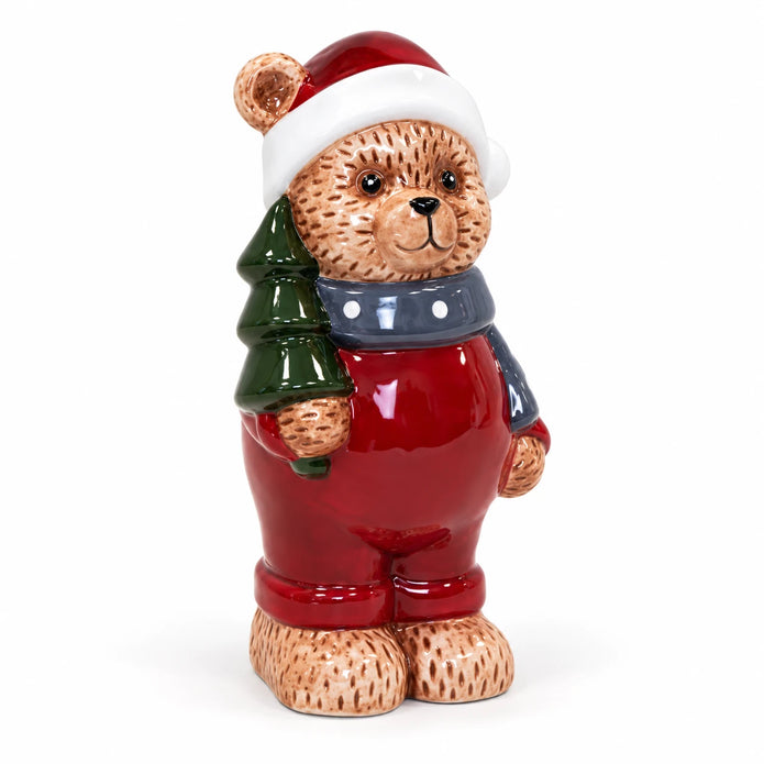 Teddy bear in red Santa hat and outfit with blue-grey scarf on white background