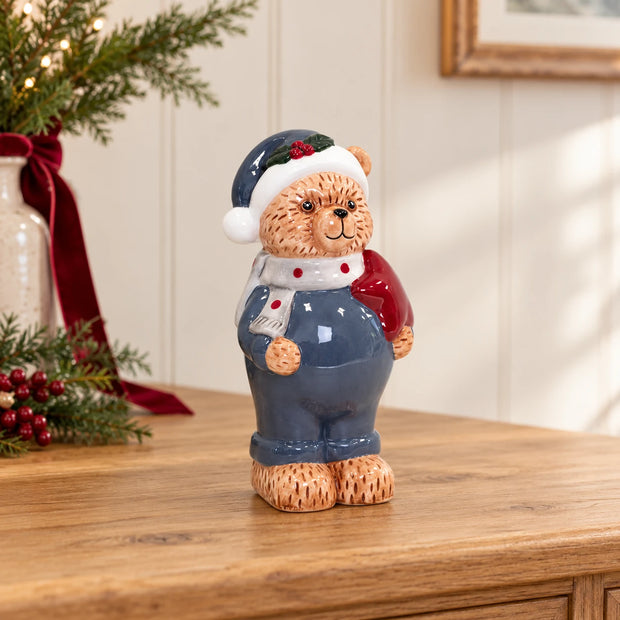 Teddy Bear in Winter Blue ornament on an oak console with understated Christmas greenery