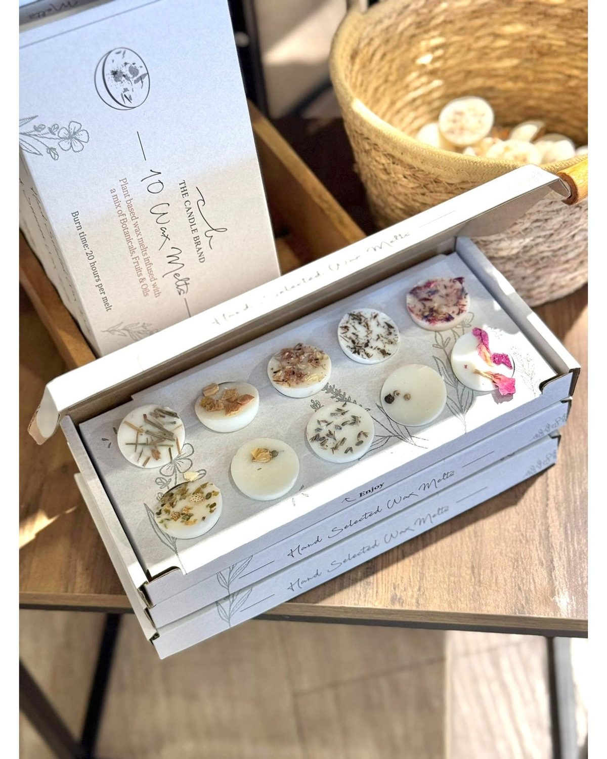Gift box of ten assorted wax melts from The Candle Brand Ltd, featuring a variety of fragrant wax melt pieces in a decorative box.