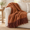 Tweedie cinnamon brushed herringbone throw draped over a cream sofa